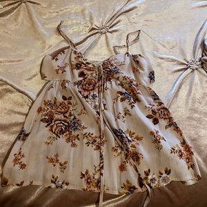 Cute floral tank top with cutouts on the sides!